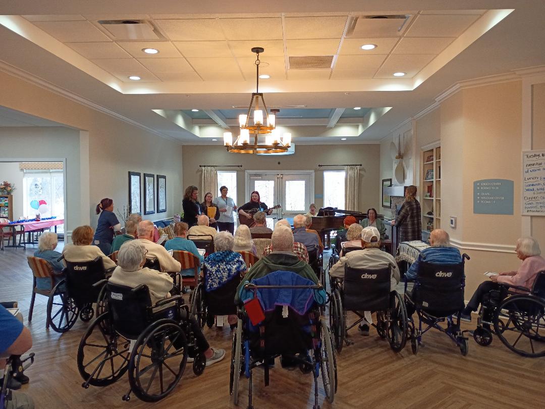 Seniors enjoying painting, fitness, outdoor drinks, and a chef-served meal at Lakeshore Woods Seniors, showcasing active, social living.