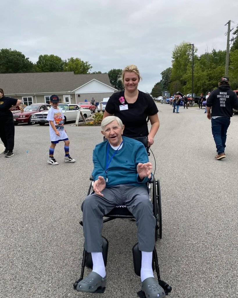 Senior recovering in assisted living facility with the help of a caregiver.