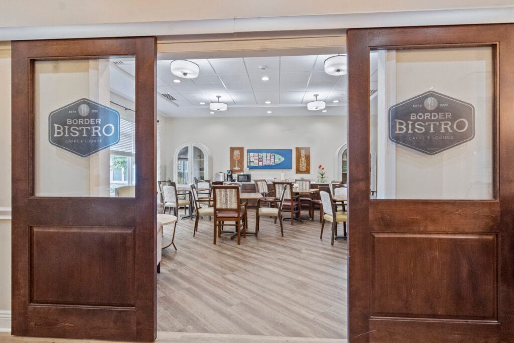 Glass entry doors leading into the Border Bistro dining room at Lakeshore Woods.